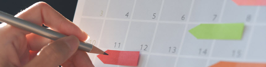 woman writing on calendar