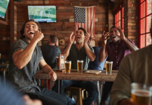 men cheering at sports bar